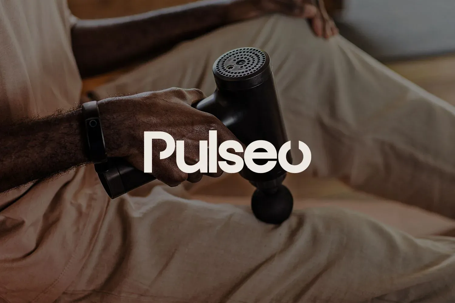Pulseo: شعار Pulseo فوق يد تمسك جهاز تدليك