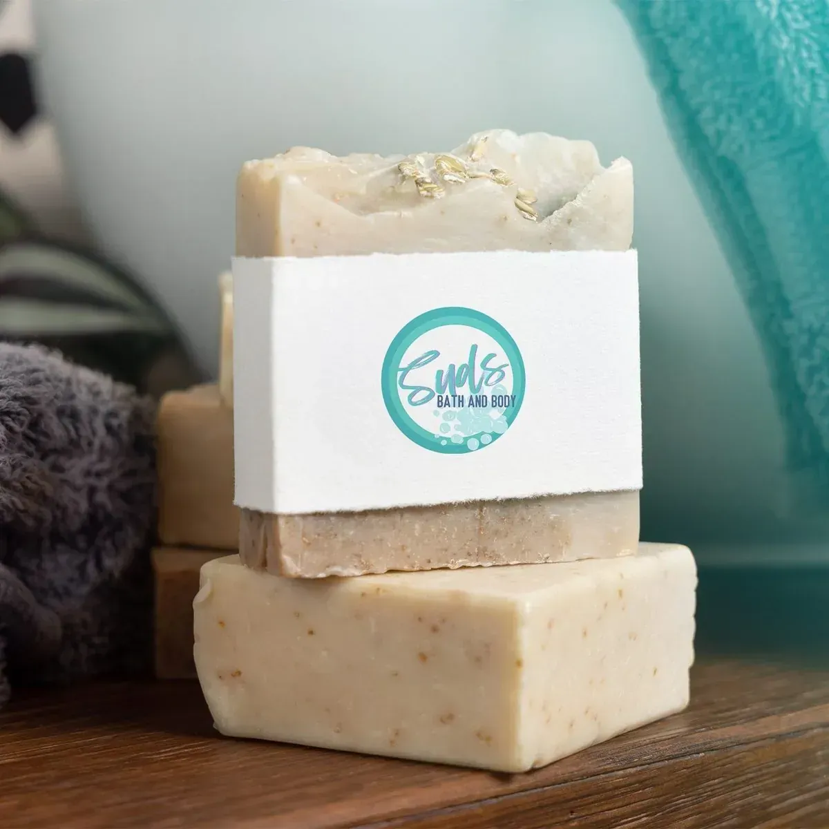 Suds Bath and Body: the Suds logo on the label of a stack of soap bars